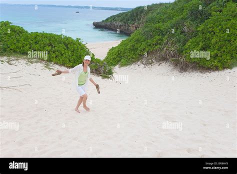 Mature Woman Walking On Sand Beach Stock Photo Alamy