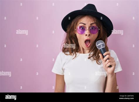 Beautiful Brunette Woman Singing Song Using Microphone Scared And