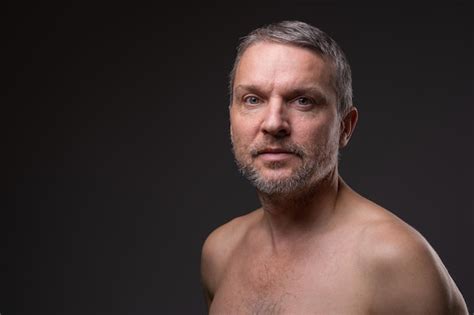 Premium Photo Portrait Of Middleaged Man With Beard And A Naked Torso On A Dark