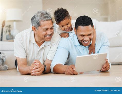 Love Never Fails A Mature Man Laying With His Son And His Grandson On The Floor While Using A