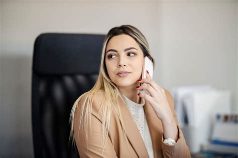 Premium Photo A Serious Businesswoman Is Sitting At The Office And