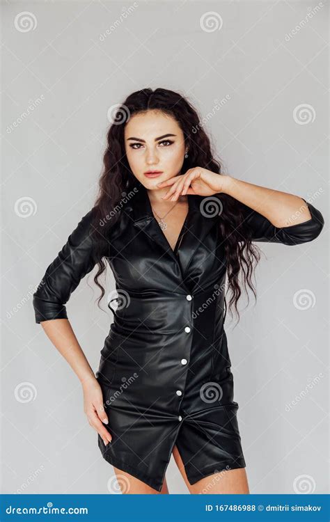 Beautiful Fashionable Brunette Woman In A Black Leather Dress Stock Photo Image Of Body