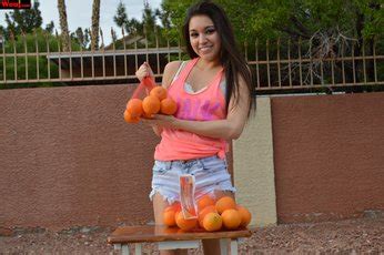 Hot Brunette Girl Selling Oranges On The Corner Of The Street Photos