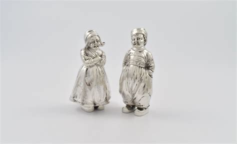 Pair Of German Silver Peppers Modeled As A Dutch Boy And Girl In