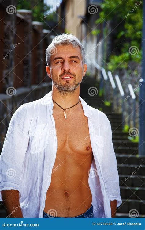 Fashion Portrait Hot Male Model In Stylish Jeans And Shirt With Muscular Body Posing Wolves