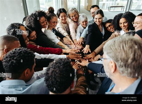 Diverse Team Demonstrating Teamwork And Inclusion At A Conference