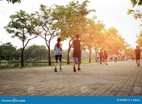 Group Of People Jogging In The Park Editorial Photography Image Of