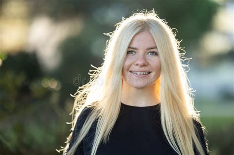 Smiling Woman With Braces With Long Blonde Hair Posing In The Park Stock Photo Image Of