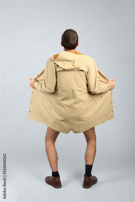 Exhibitionist Exposing Naked Body Under Coat On Light Background Back View Stock Photo Adobe