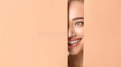Woman With Nude Makeup Peering Into Hole In Peach Paper Stock Image Image Of Collagen Clean
