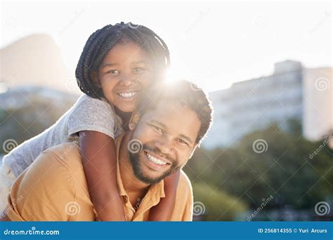 Happy Black Father Carrying Girl Child Or Kid Outdoors In Nature Park