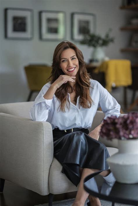Brunette Haired Female Relaxing In An Armchair In Her Modern Home Stock Photo Image Of Middle