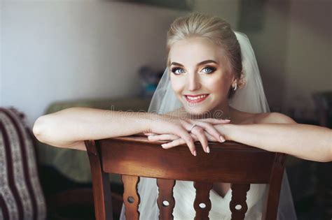 Gorgeous Innocent Blonde Bride Posing While Sitting On Chair Fa Stock Image Image Of