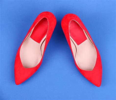 Premium Photo Beautiful Red Female Shoes On Blue Background