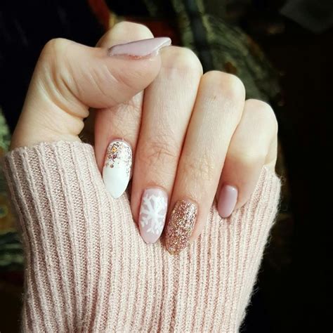 Nude Pink White And Rose Gold Gel Nails With A Snowflake Nail Art Pink Gel Glitter Nails