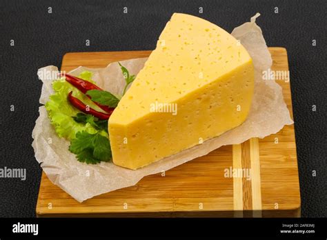 Piece Of Yellow Cheese Served Herbs Stock Photo Alamy