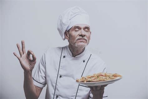 Senior Male Chief Cook in Uniform Gesturing Okay Sign and Holding Pizza ...