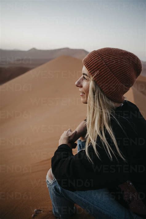 Namibia Namib Desert Namib Naukluft National Park Sossusvlei Smiling Woman Sitting On Dune