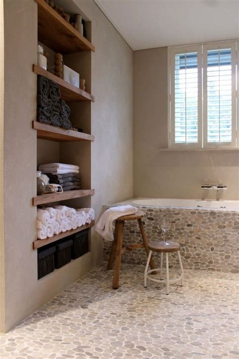 Rustic Zen Bathroom With River Rock Tile Flooring And Simple Towel