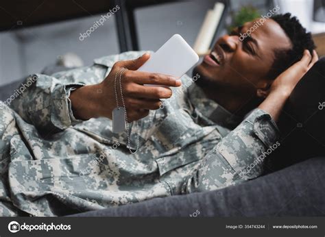 Stressed African American Soldier Crying While Holding Army Badge