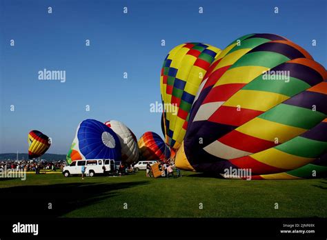 People Blowing Up Balloons At A Hot Air Balloon Festival In Travers City Stock Photo Alamy
