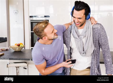 Smiling Gay Couple Listening To Music Stock Photo Alamy