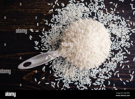 measuring cup full  uncooked long grain rice  stainless steel