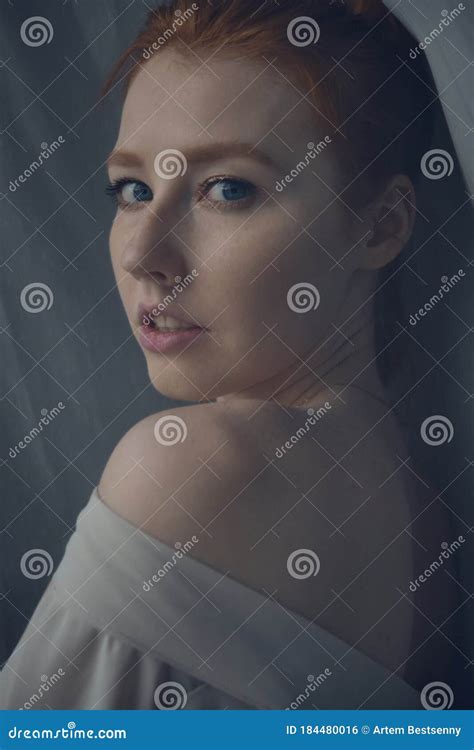Redhead Girl Looking At The Camera Over Her Naked Shoulder Frame