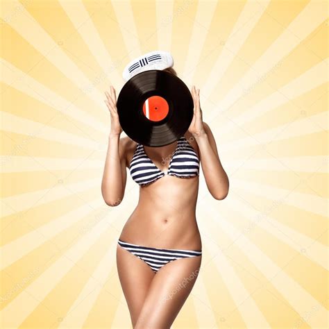 Bikini And Vinyl Beautiful Pinup Bikini Model Hiding Behind An Lp Microgroove Vinyl Record On