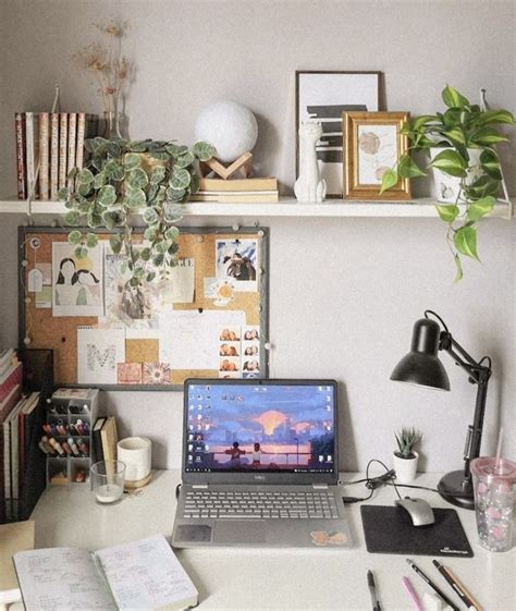 An Open Laptop Computer Sitting On Top Of A White Desk Next To A Potted