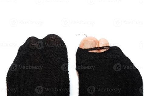 Closeup shot of male feet in hoaly socks with sticking out toe