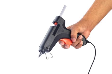 Premium Photo Hand Holding Electric Hot Glue Gun Isolated