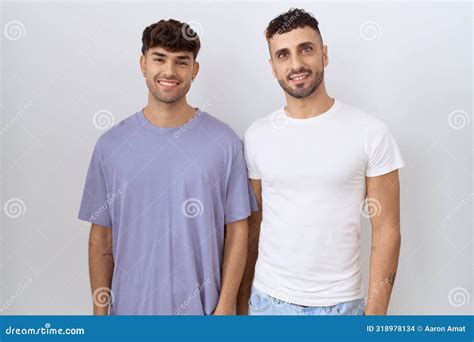 Homosexual Gay Couple Standing Over White Background With A Happy And Cool Smile On Face Stock