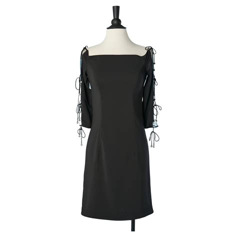 Black cocktail dress with see-through sleeves and Rhinestone pompoms