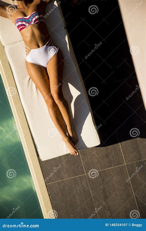Beautiful Tanned Woman In Bikini Relaxing Near Luxury Swimming Pool Stock Image Image Of