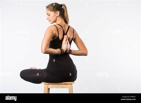 Feel Relaxed Young Pleasant Woman Sitting In Lotus Pose On Chair With