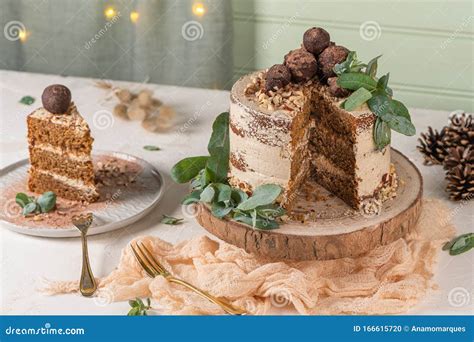 Slice Of Delicious Naked Chocolate And Hazelnuts Cake On Table Rustic Wood Kitchen Countertop