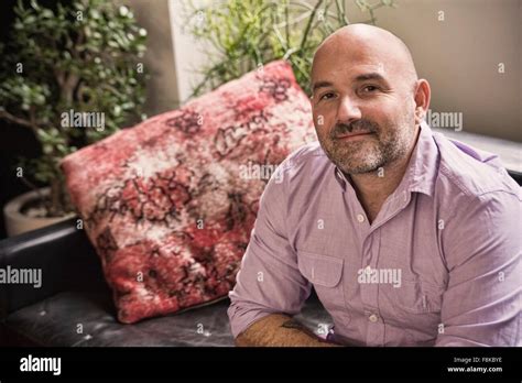 Portrait Of Confident Mature Man Sitting On Sofa Stock Photo Alamy