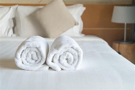 Premium Photo White Towel On Bed In Bedroom