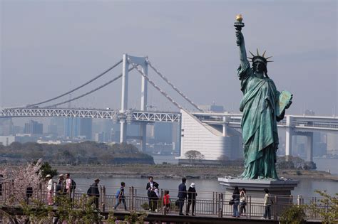 Replica Of The Statue Of Liberty And The Rainbow Bridge At Odaiba