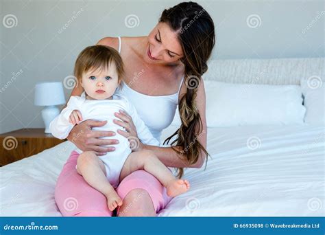 Smiling Brunette Woman Holding A Cute Baby Stock Photo Image Of Care Domestic 66935098