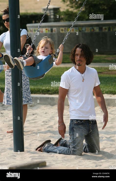 Chris Cornell And His Son Christopher Playing On The Swings As The