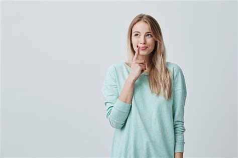 Free Photo Caucasian Female Model With Long Blonde Hair Dressed Casually Looks Aside With