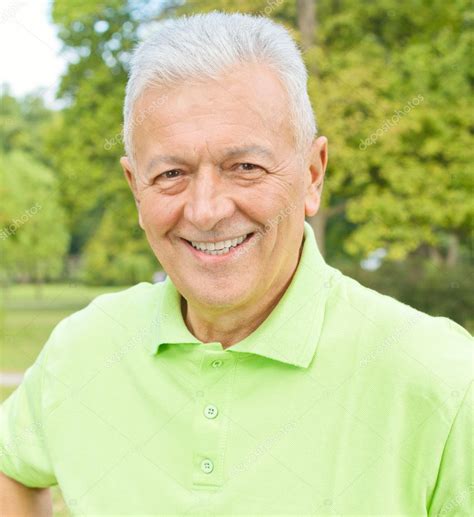 Portrait of smiling old man in the park — Stock Photo © MitaStockImages ...