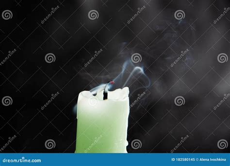 Smoke From An Extinguished Candle Isolated On A Black Background Can