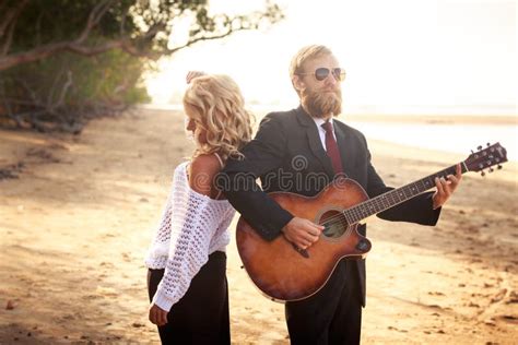 Guitarist And Blonde Girl Standing On Sandy Beach Stock Photo Image Of Musician Blonde 54415488