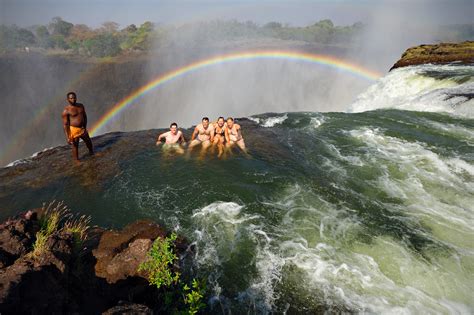 Four Tourists Swim At The Edge Of The Victoria Falls In De Flickr