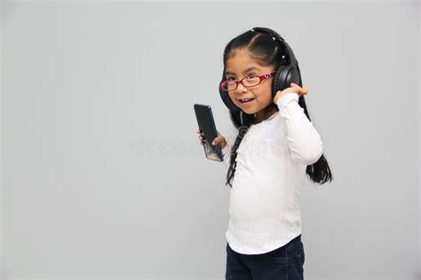 Year Old Brunette Latin Girl With Glasses Listens To Music In Her