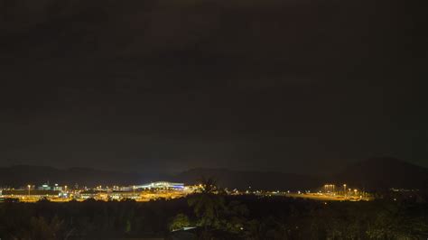 Footage of an airfield at night. Airport illuminated by lights. Traffic ...