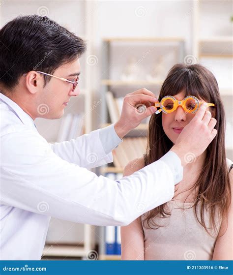 Ophthalmologist is Checking Up Patient in Eye Doctor Hospital Stock